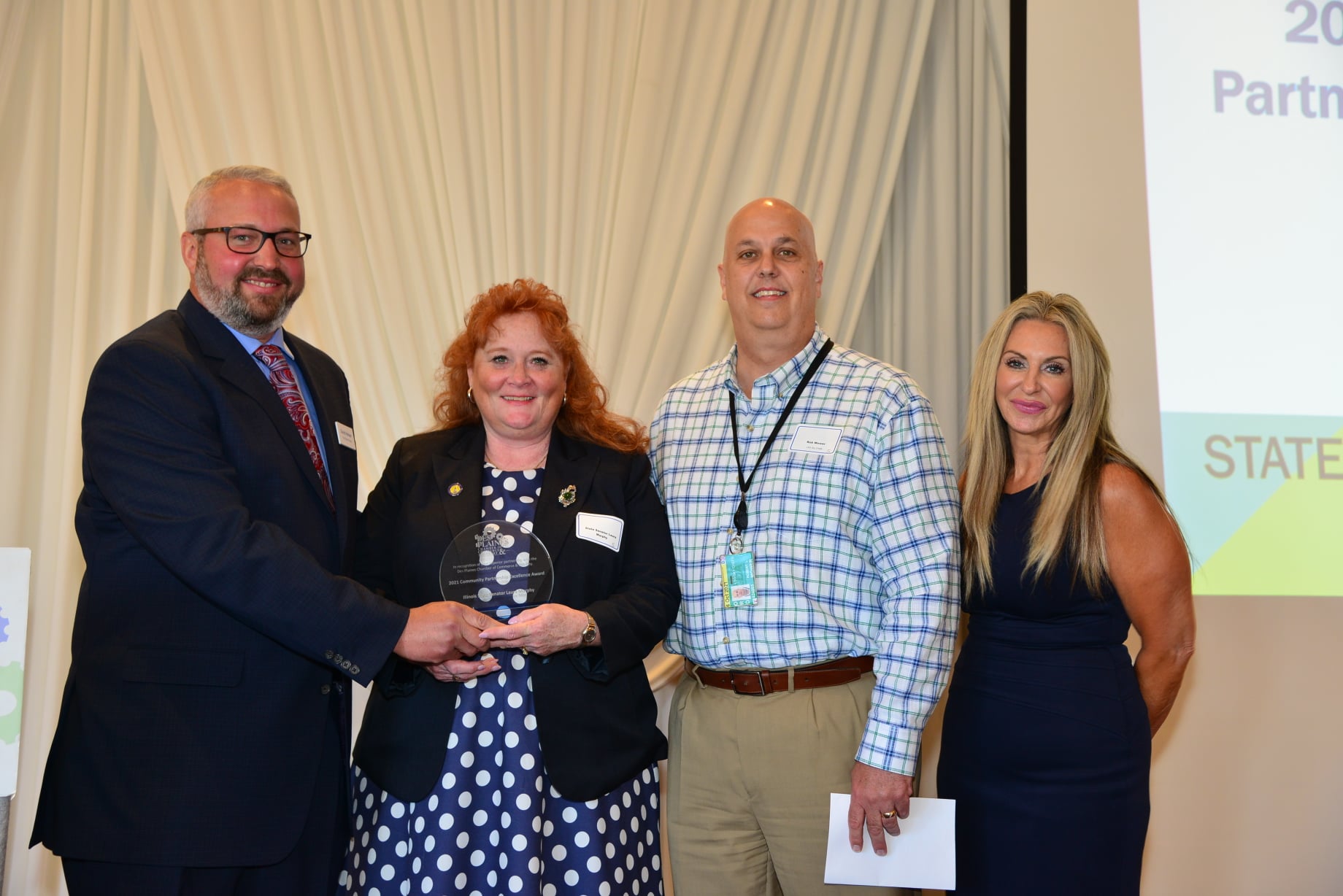 State Senator Laura Murphy (D-Des Plaines) receives the 2021 Des Plaines Chamber Community Partnership Excellence Award from the Des Plaines Chamber of Commerce & Industry on Wednesday, June 16, 2021. From left to right: President of the Heiser Group and 2021 Chamber Board President David Heiser, Senator Laura Murphy, General Manager of LSG Sky Chefs Rob Mower, and Chamber Executive Director Andrea Biwer.